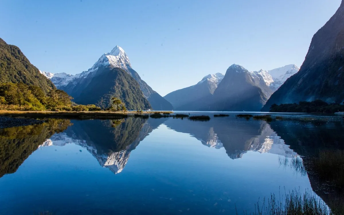 Mitre Peak mirrored in the still water of Milford Sound