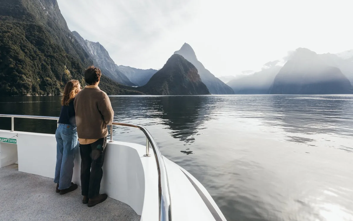 Passengers on the bow of a cruise boat in Milford Sound