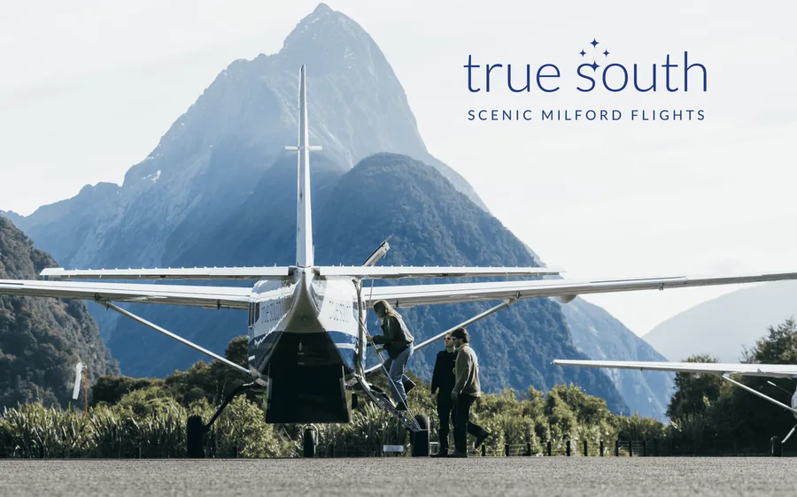 A scenic aircraft on the apron below Mitre Peak