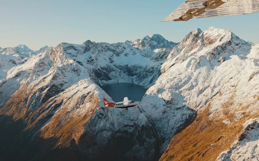 A light aircraft over the peaks above Milford Sound