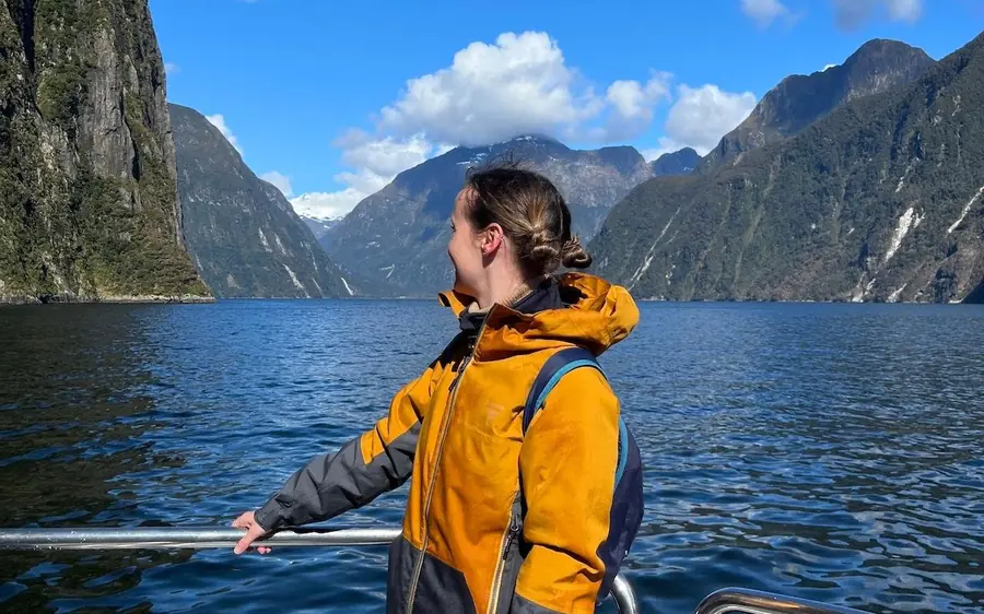 A passenger on the deck looking down Milford Sound