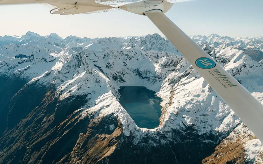 The wing of a light aircraft over the Southern Alps
