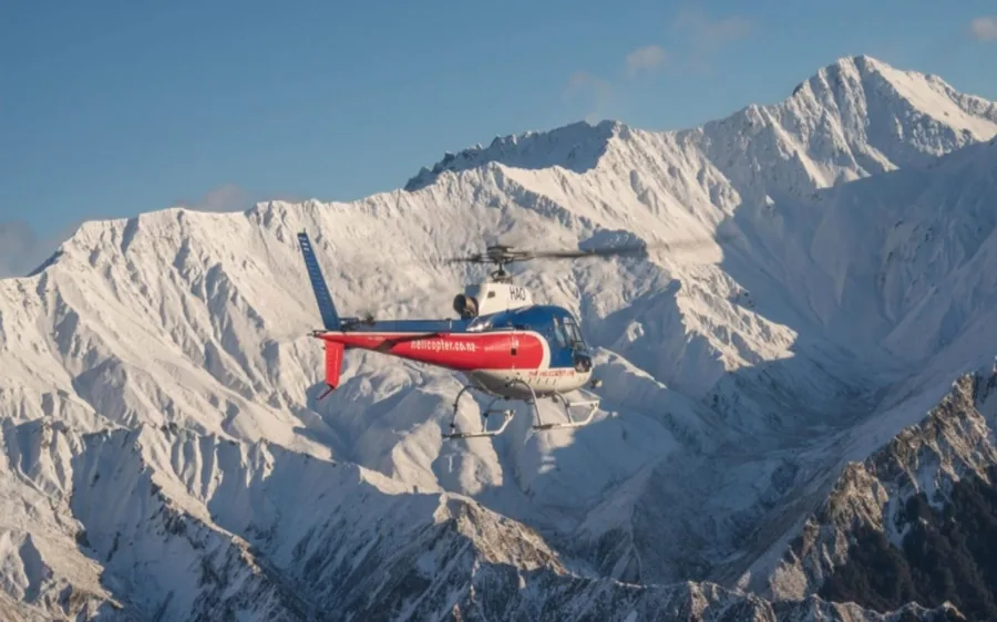 A helicopter above the snow-covered Southern Alps